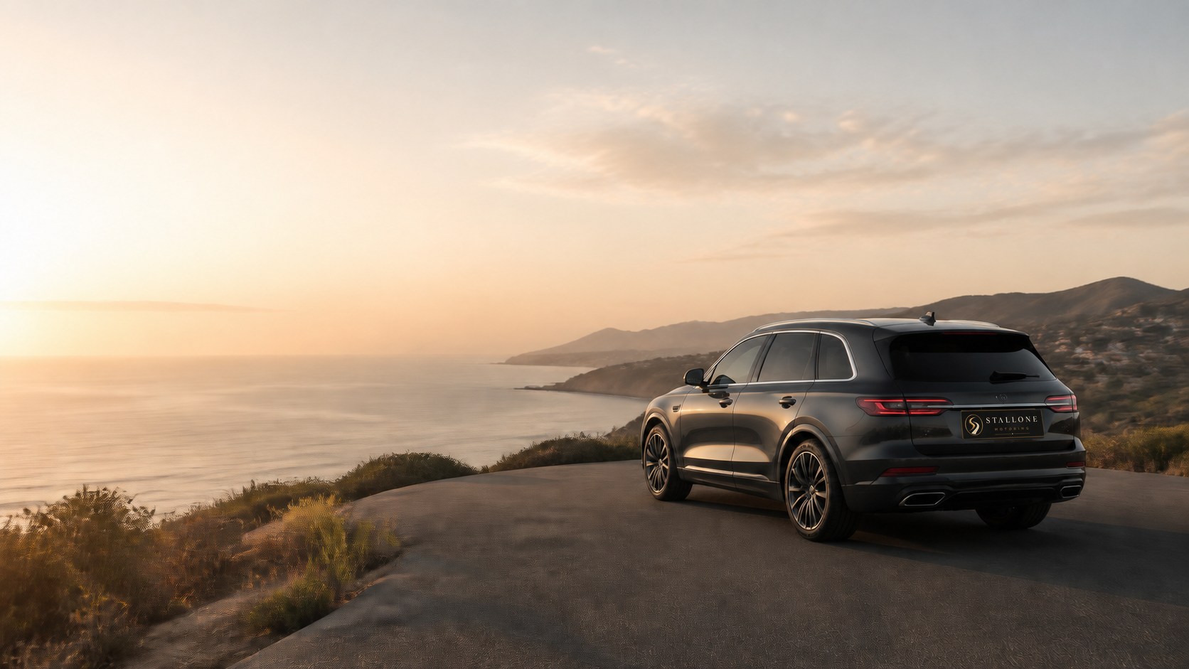 Dark luxury SUV on a Southern California coastal road